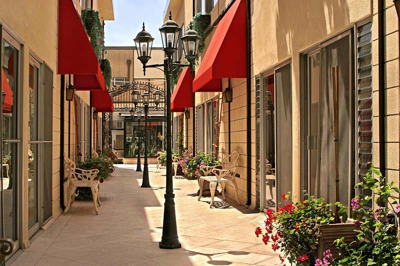 A bright, well-kept courtyard with flowers and seating