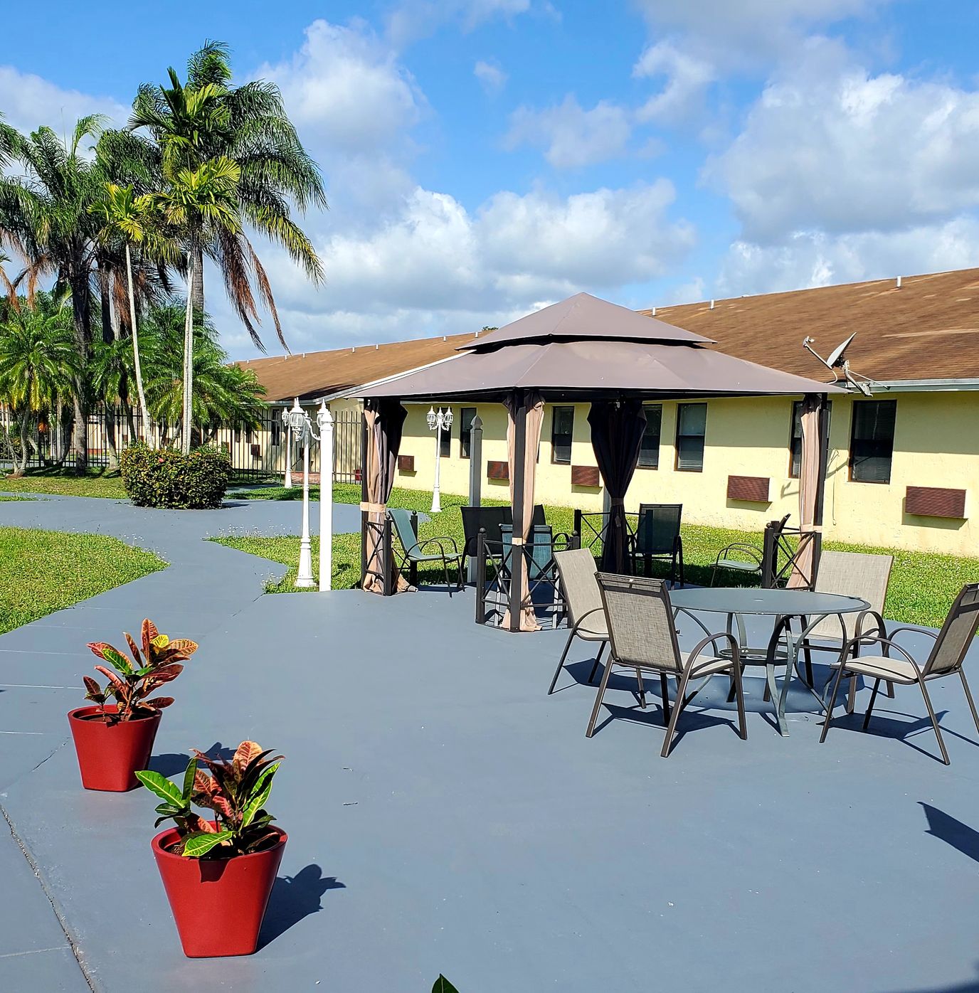 Outdoor seating area with tables and plants