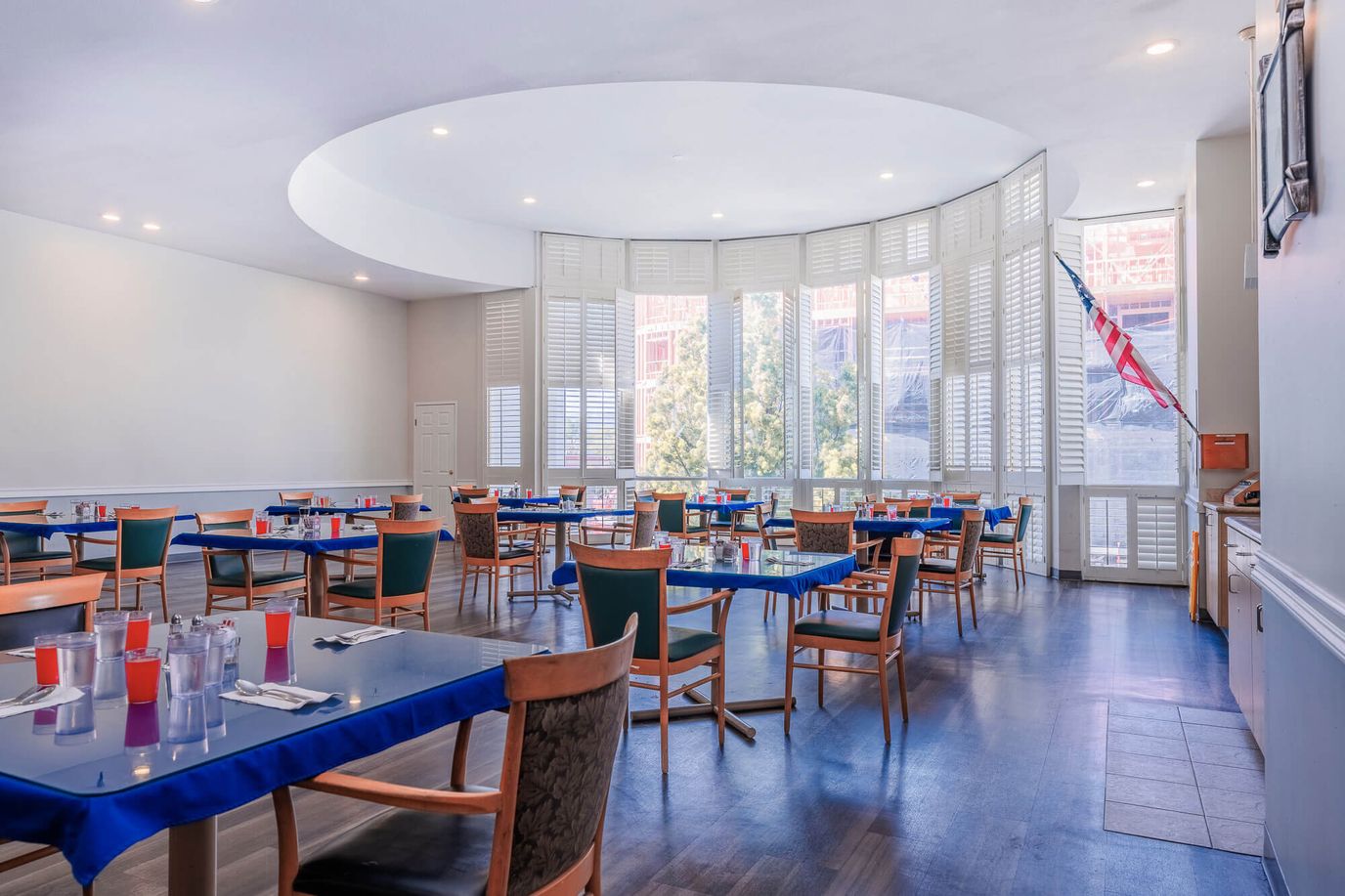Bright dining room with tables set for meals