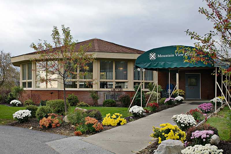 Exterior view of the Mountain View Center with flowers