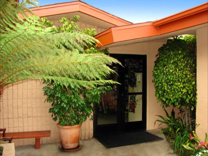 Entrance to a facility with greenery and welcoming features