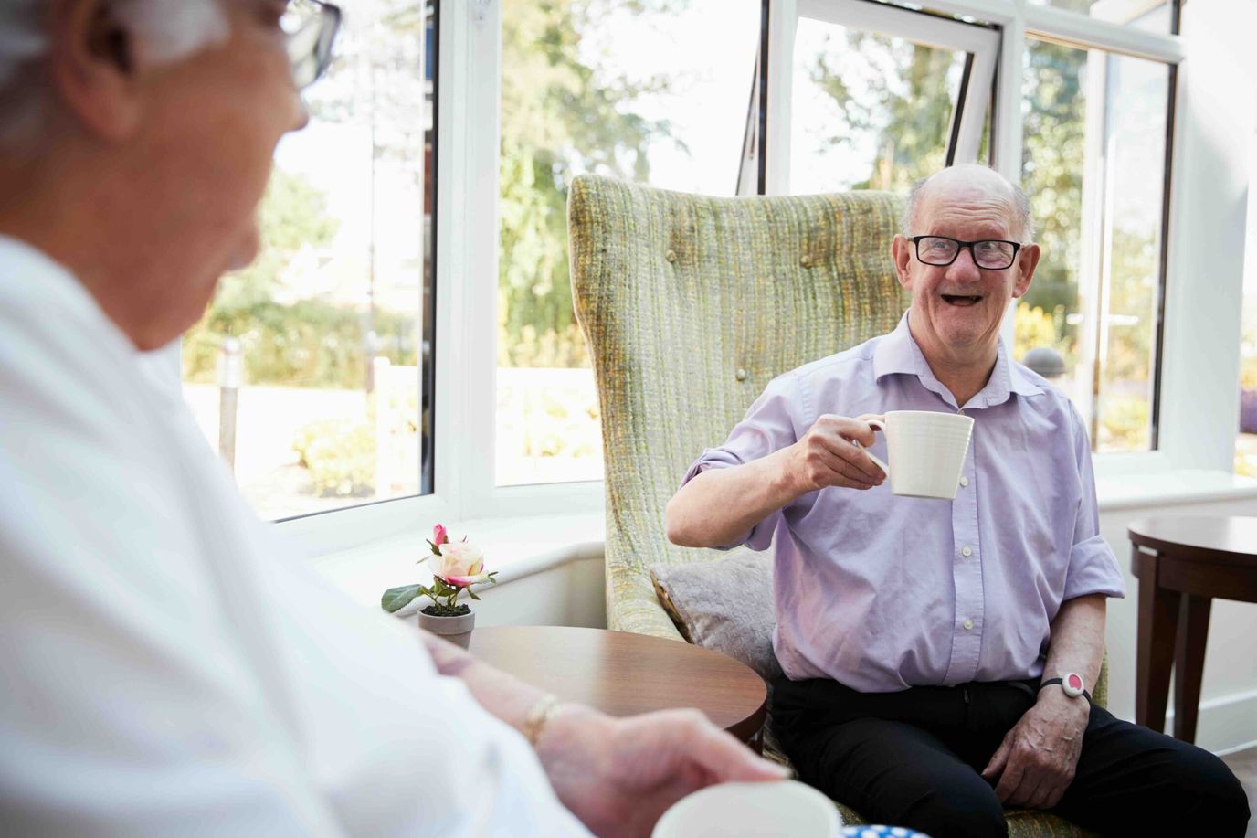 Residents enjoying tea in a bright common area