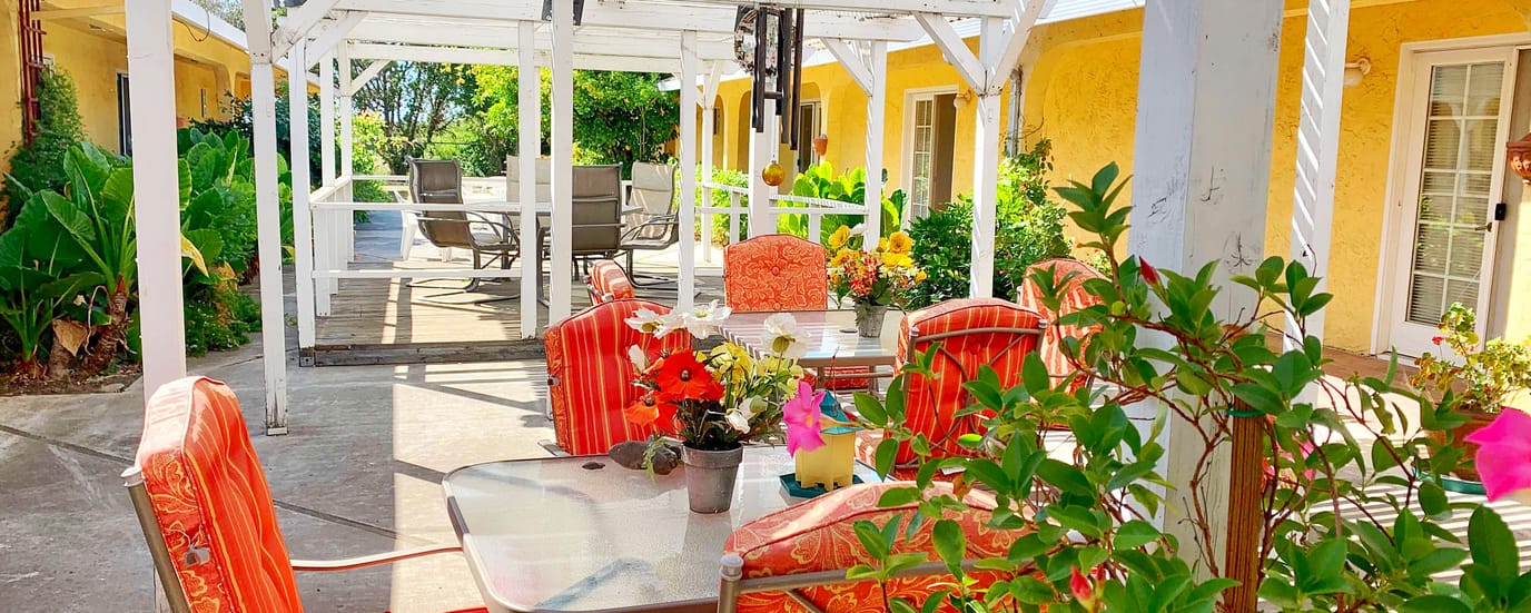 Outdoor seating area with flowers and patio furniture
