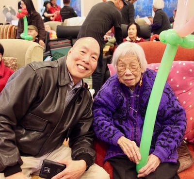 Resident and staff member smiling in a common area