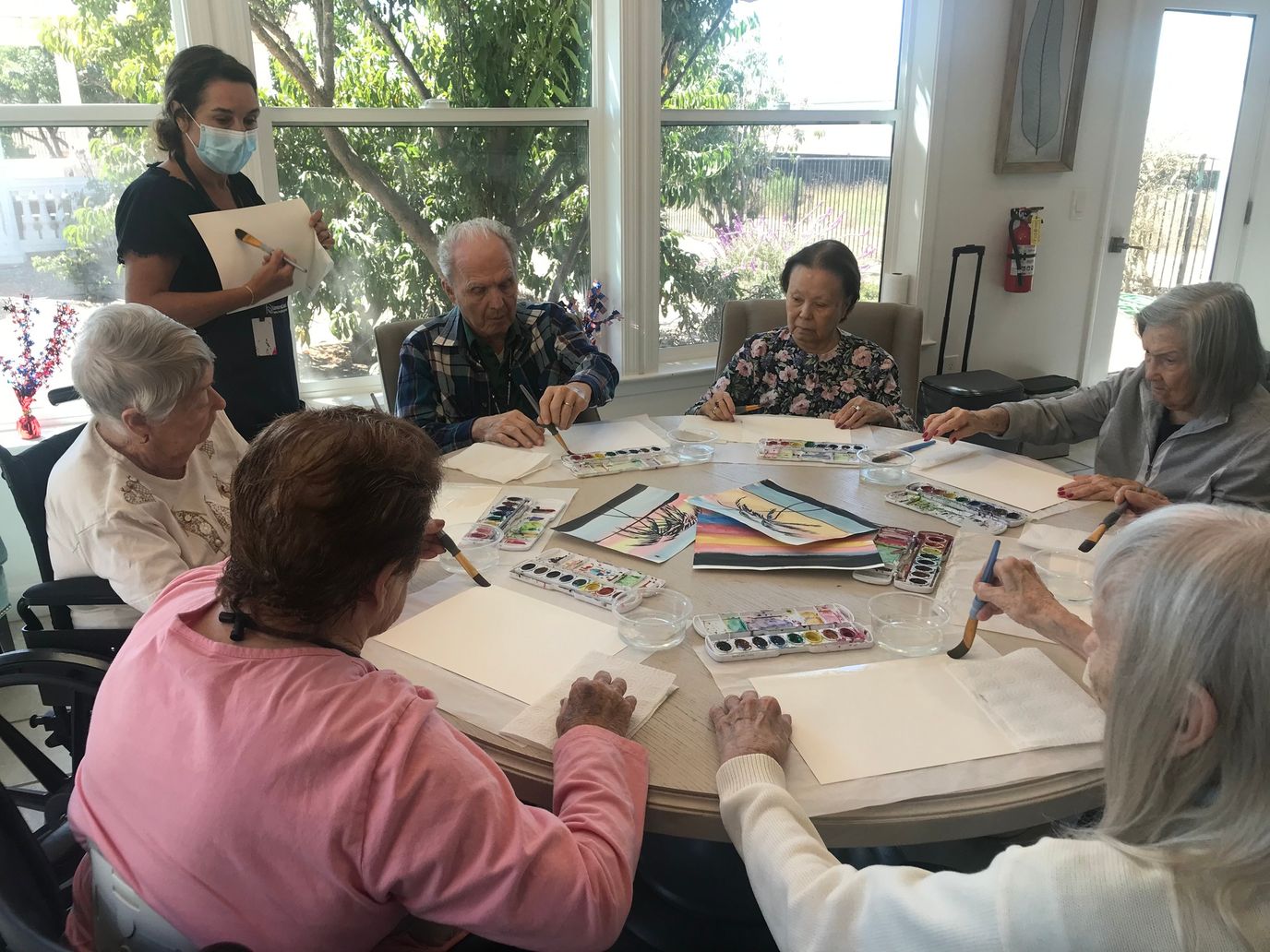 Residents participating in a watercolor painting activity