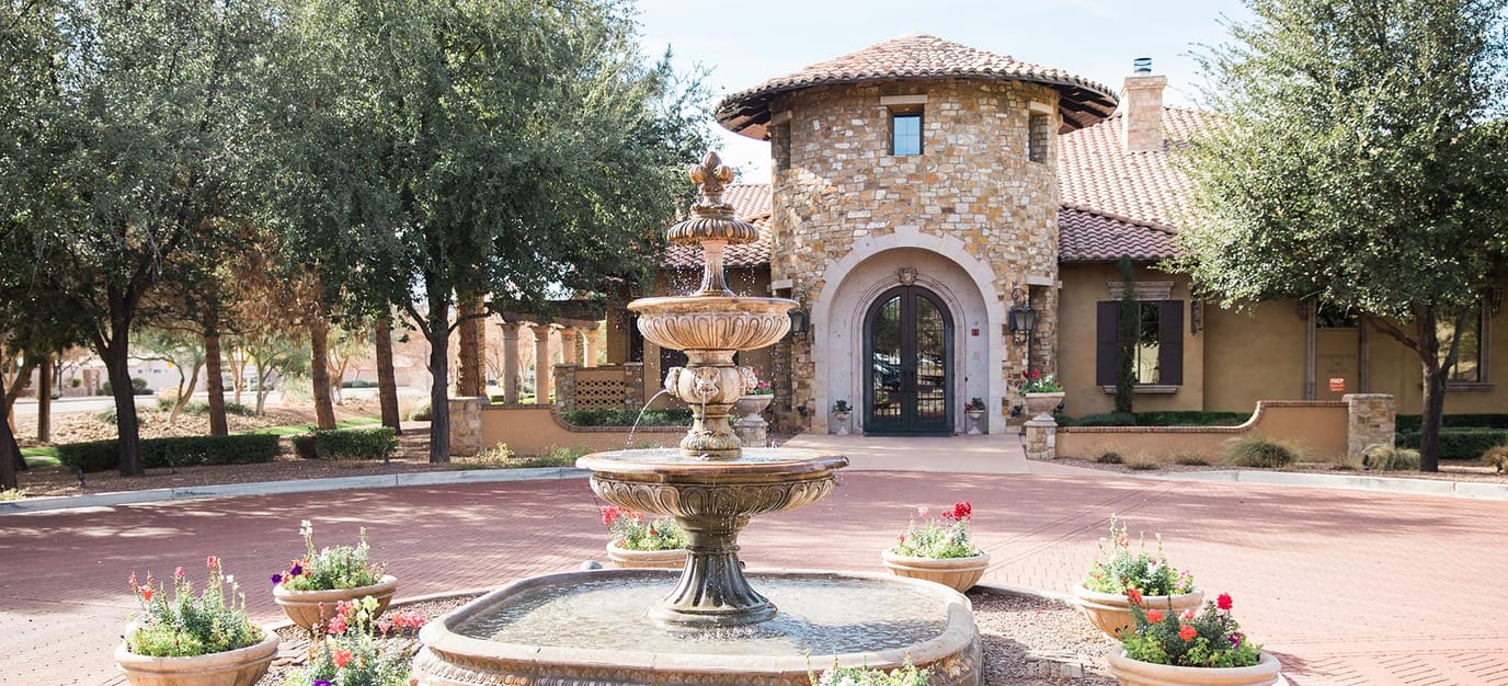 Beautiful entryway with fountain and landscaped garden