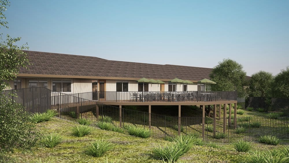 Exterior view of a senior living facility with outdoor seating