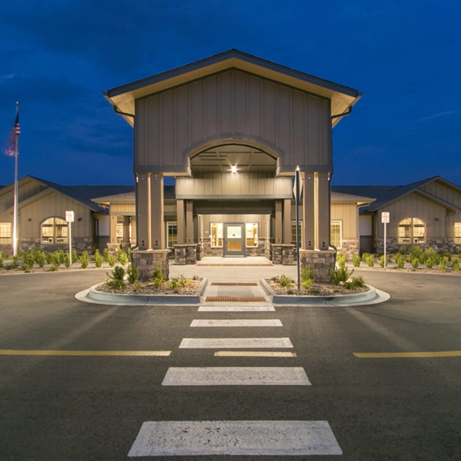 Front entrance of a senior living facility at dusk