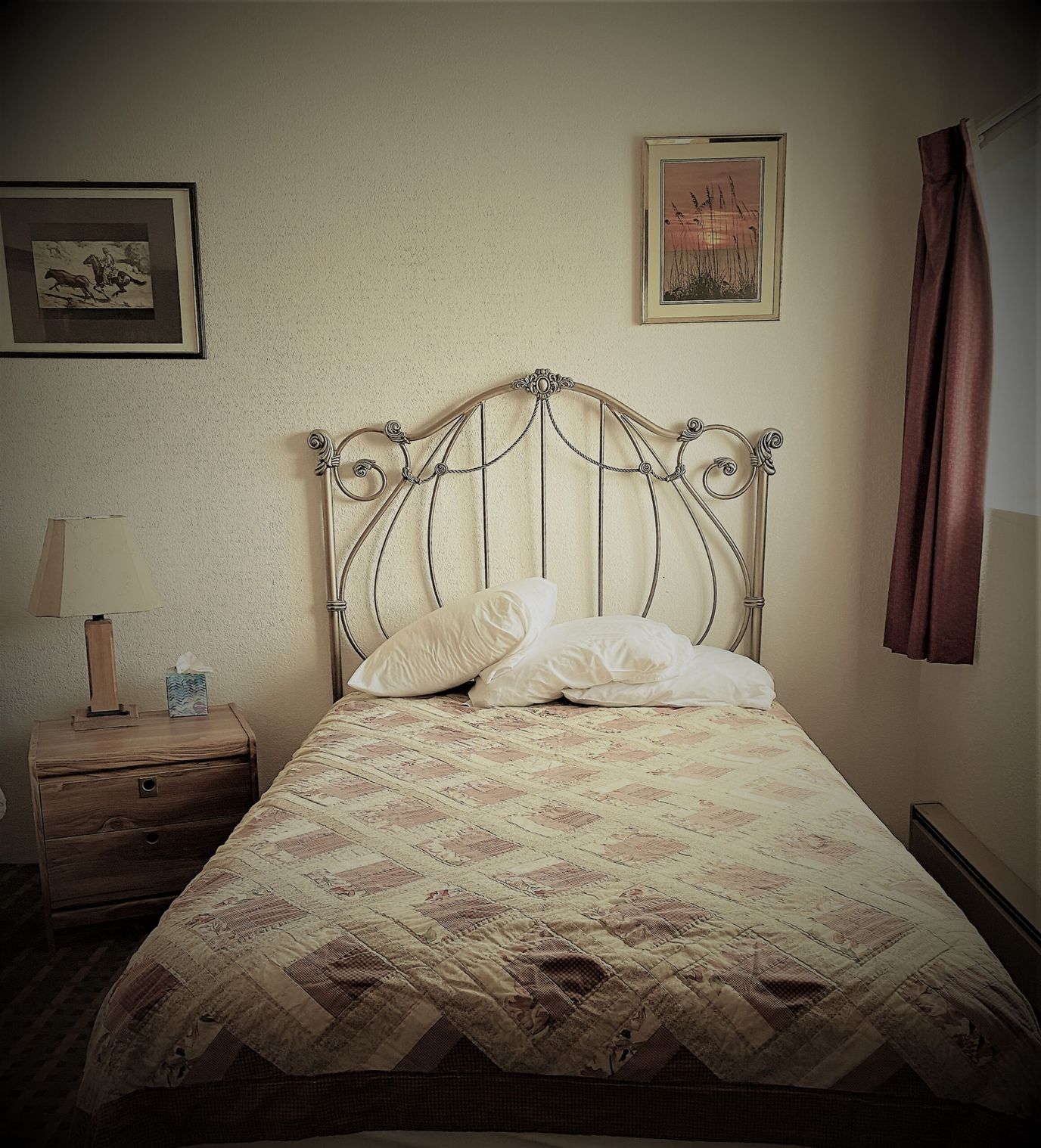 Cozy bedroom with a vintage headboard and artwork