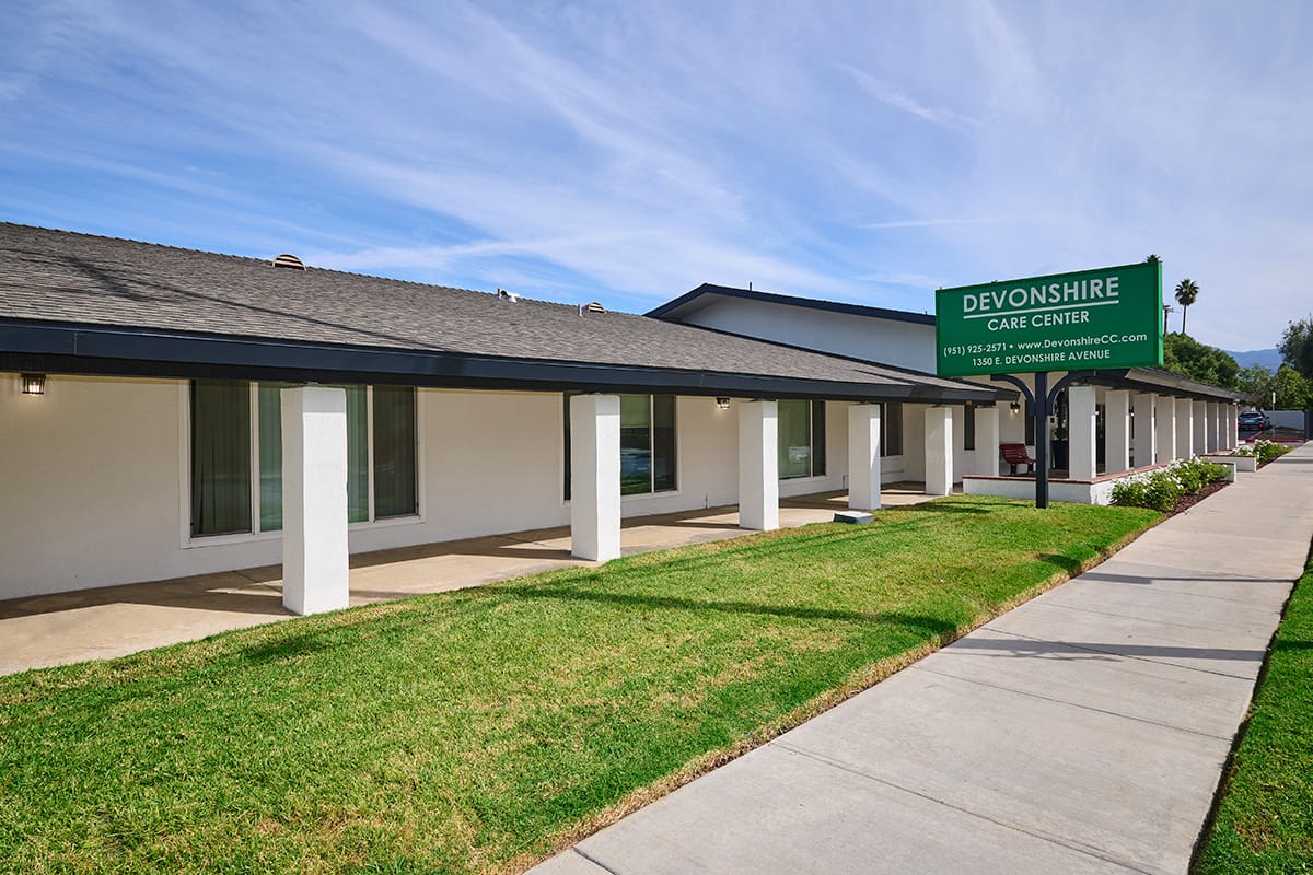 Exterior view of Devonshire Care Center with landscaped area