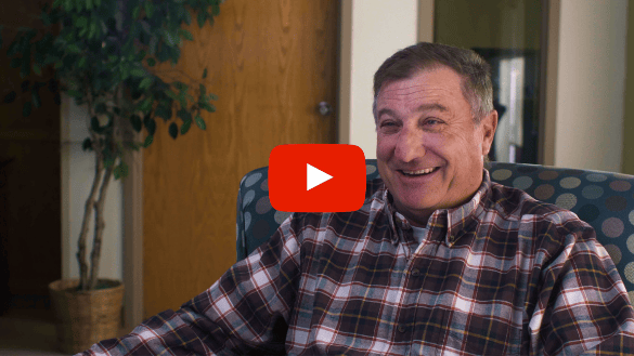 Resident smiling in a comfortable lounge area