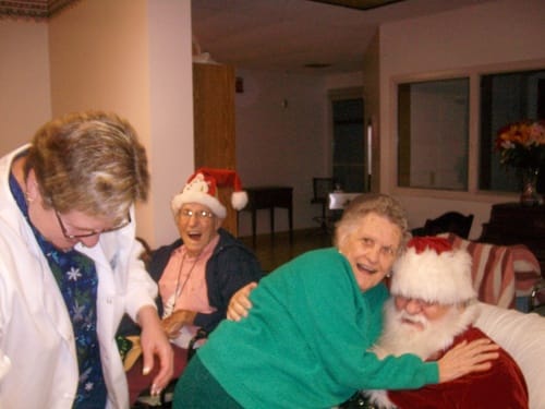Residents celebrating with Santa in a festive common area