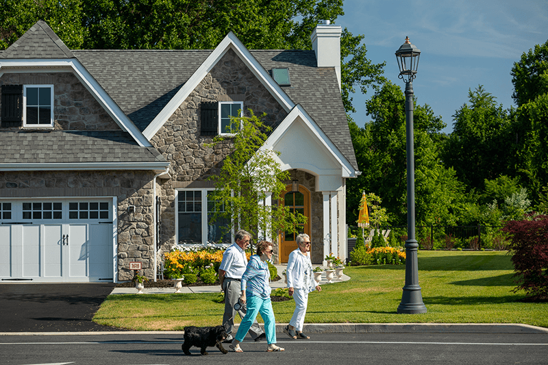 Residents walking their dog near the facility exterior
