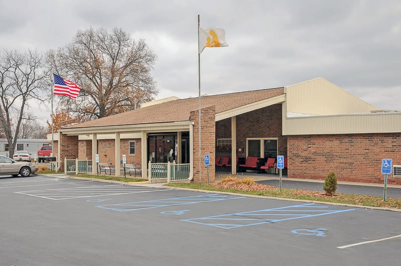 Exterior view of the facility building with parking area