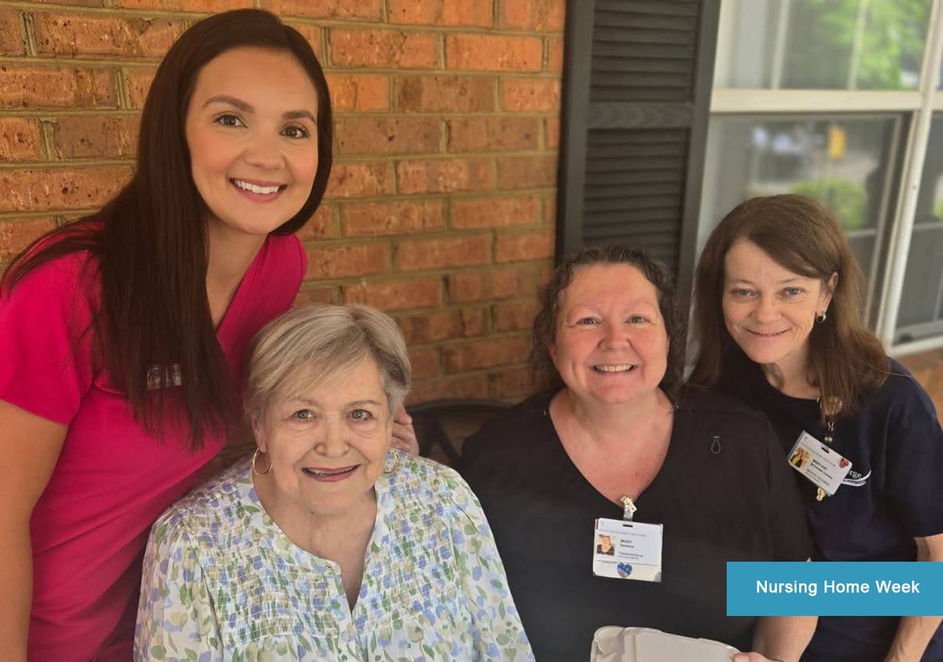 Staff and residents smiling together during an event