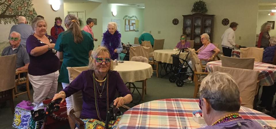 Residents celebrating with masks and decorations in a common area