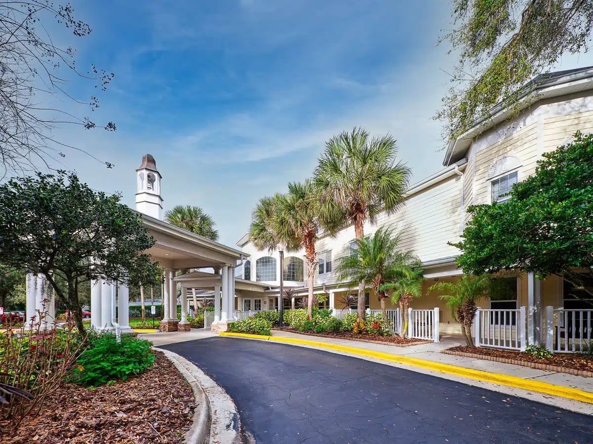 Exterior view of a senior living facility with landscaping