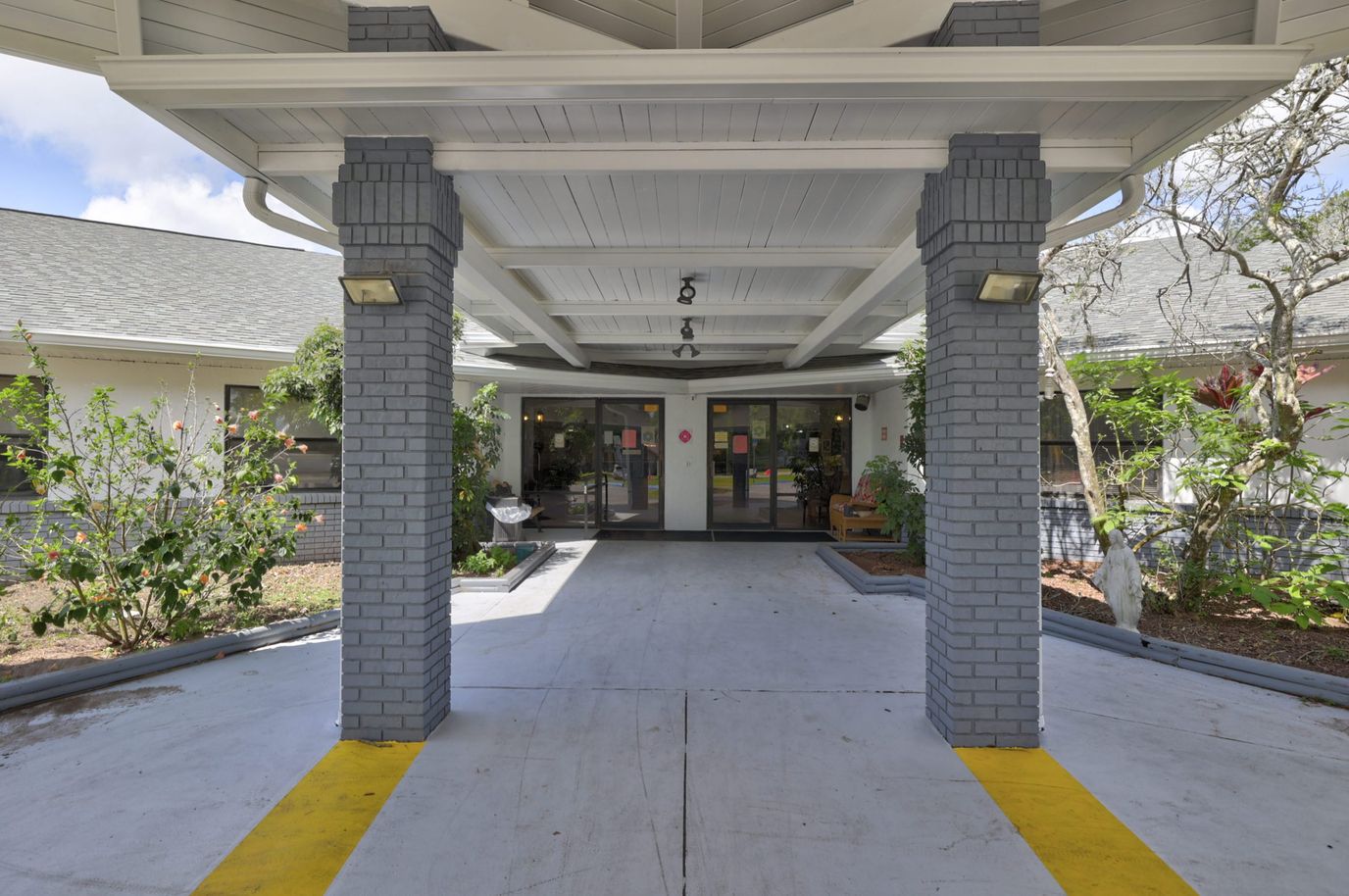 Front entrance of a senior living facility with landscaped area