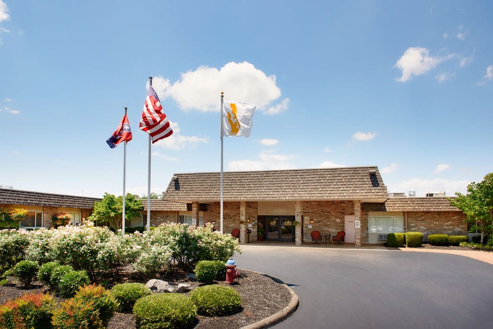 Exterior view of the facility with flags and landscaping