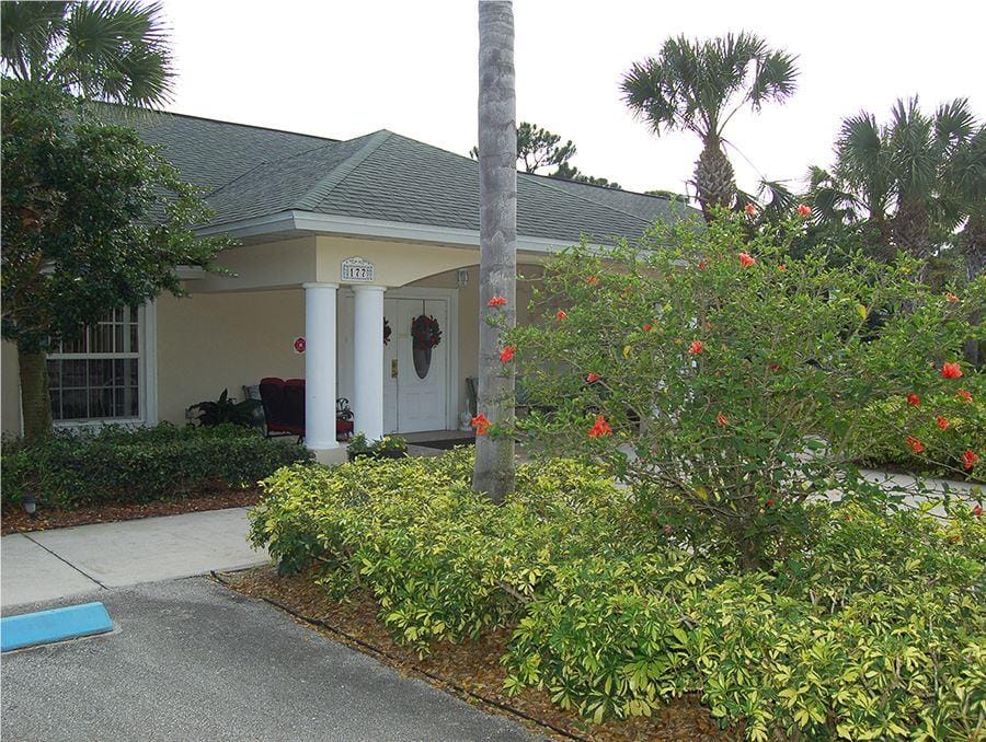 Exterior view of the building with landscaping and palm trees