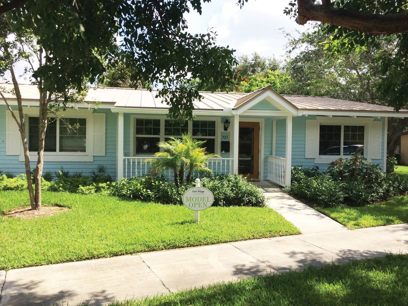 Exterior view of a small residential building with garden