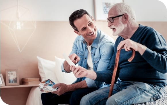 A caregiver interacting with a senior resident in a room