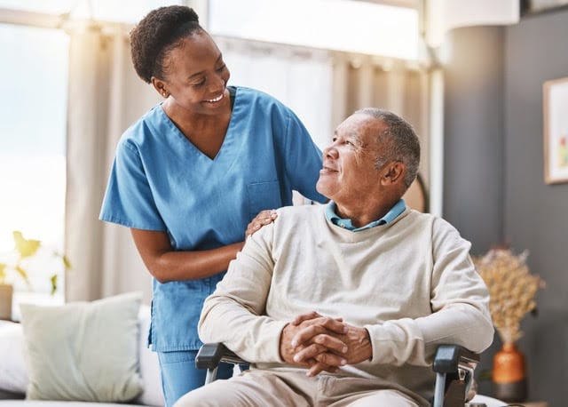Staff member assisting a resident in a cozy interior