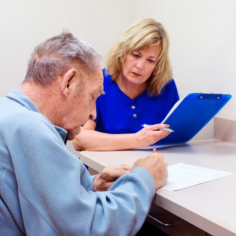 Staff assisting a resident with paperwork