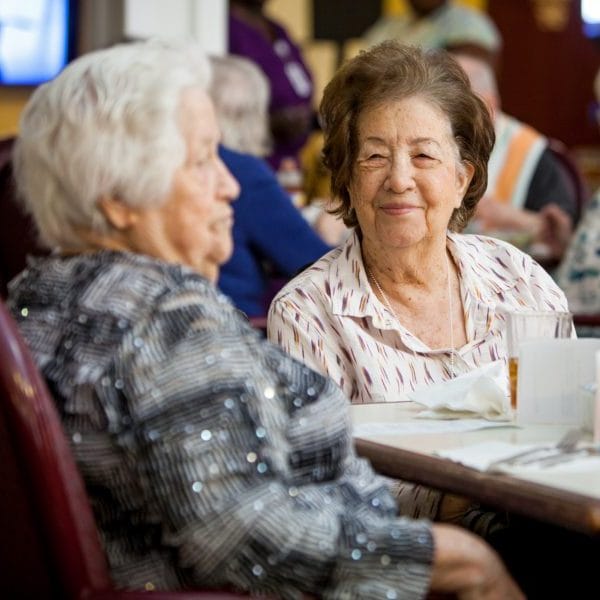 Two residents enjoying a meal in the dining area