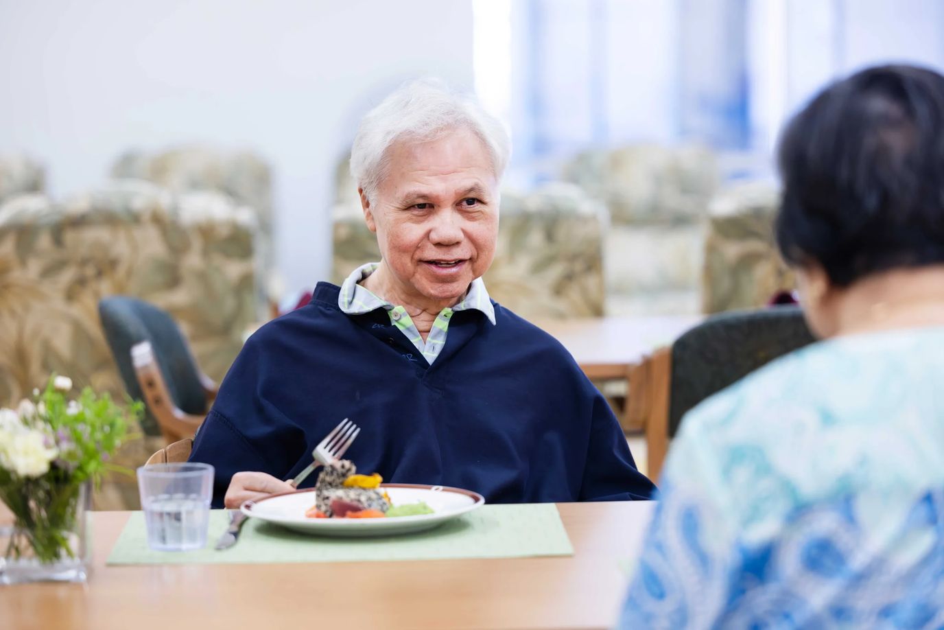 Resident enjoying a meal in the dining room