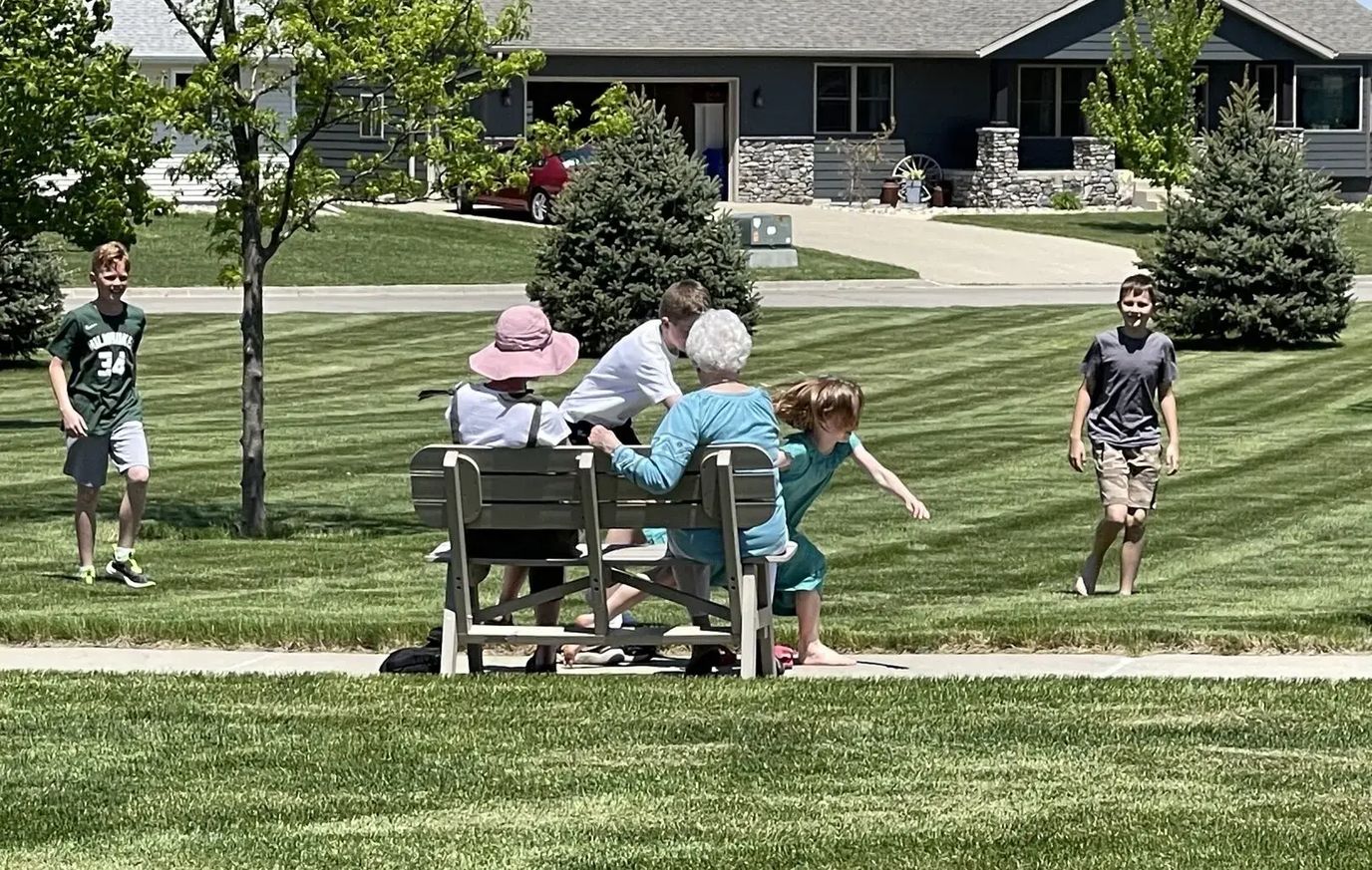 Residents and children enjoying a sunny day outdoors
