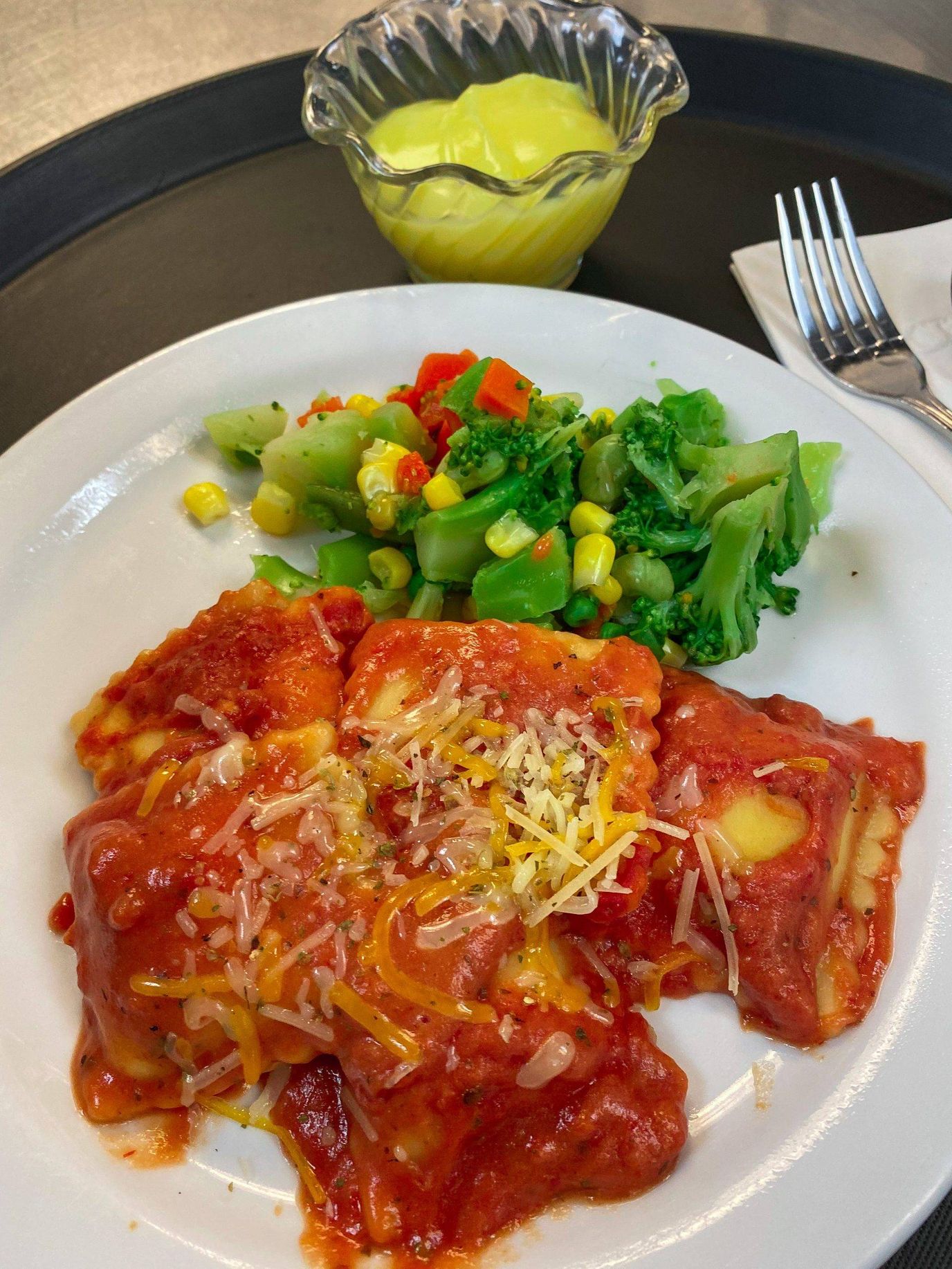 Plate of ravioli with vegetables and dessert