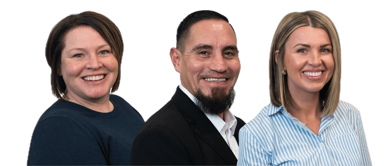 Three staff members smiling for the camera