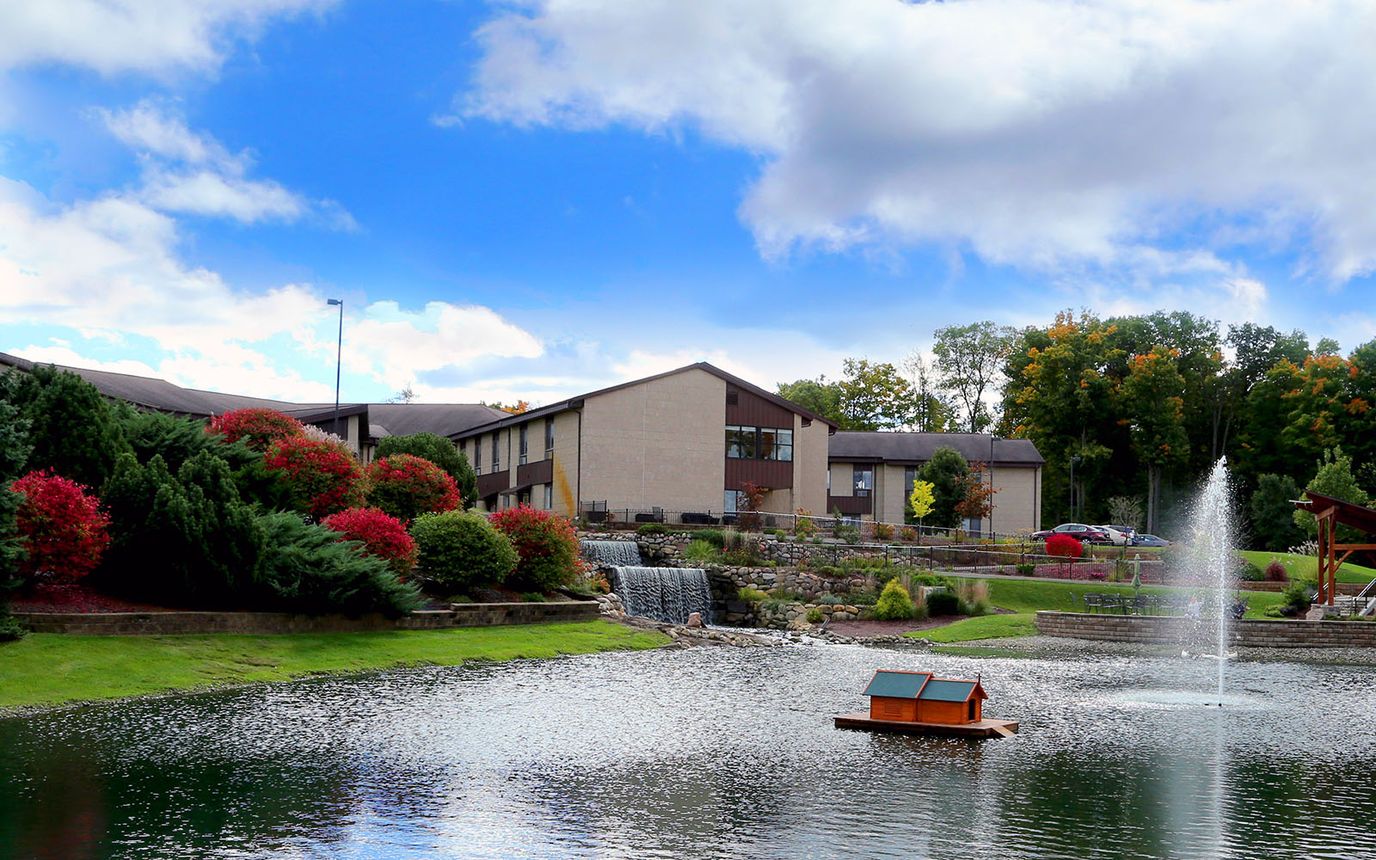 Scenic view of the assisted living facility by a pond