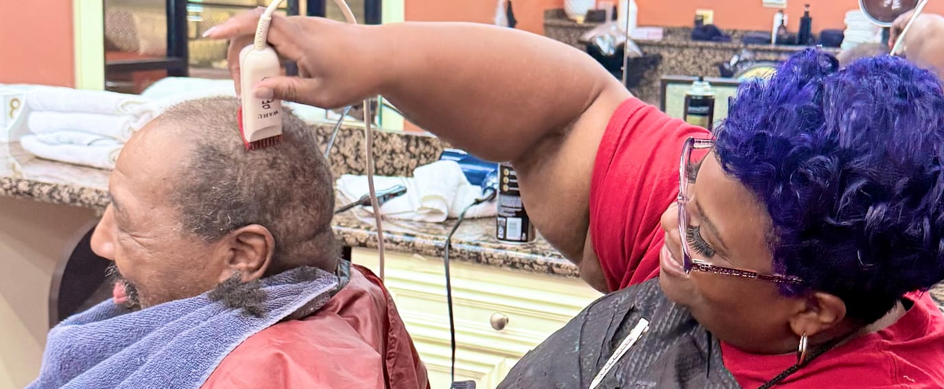 Resident receiving a haircut in the salon
