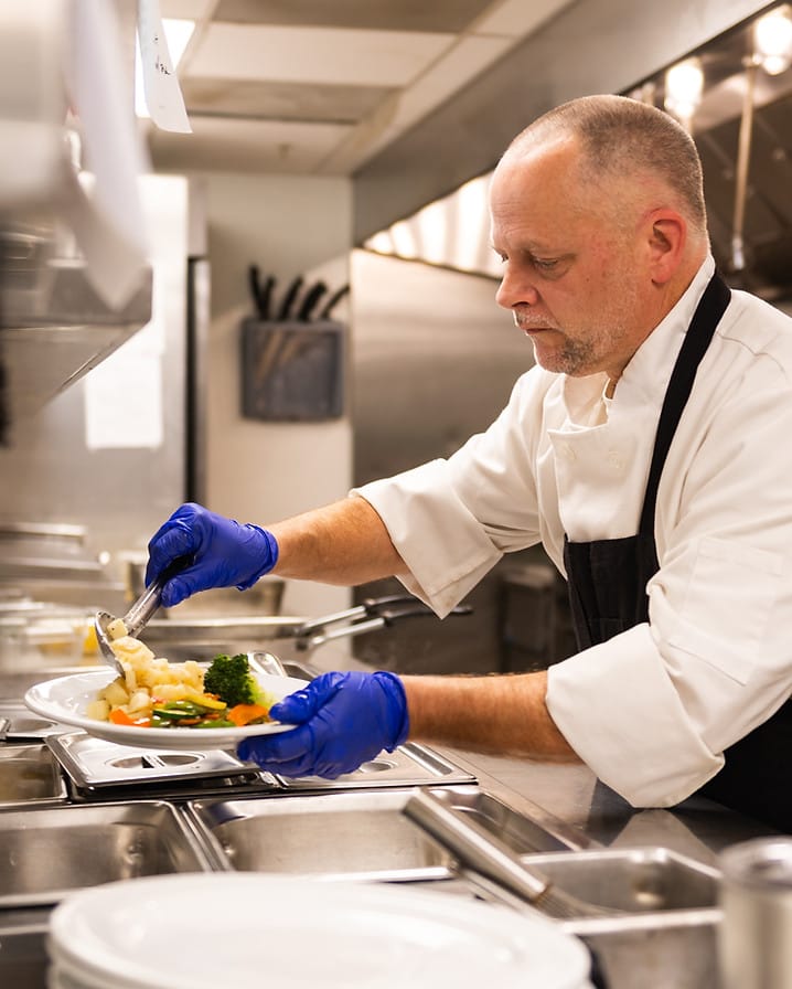 Chef preparing plated meals in the kitchen