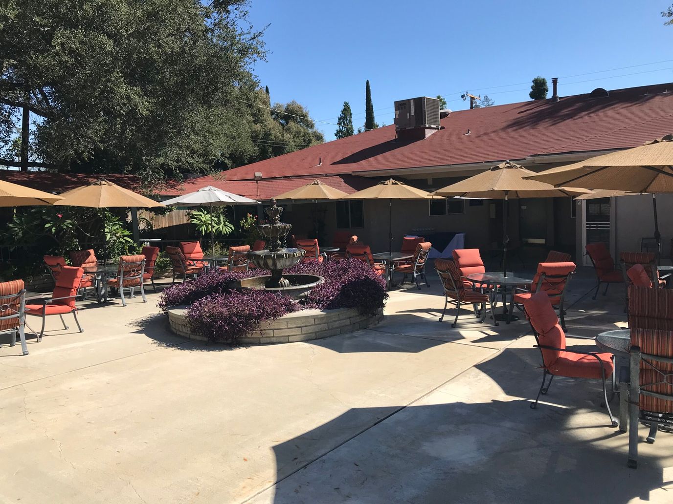 Outdoor patio area with seating and umbrellas.