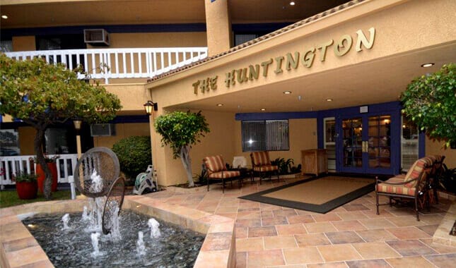 Front entrance of The Huntington with seating and fountain.