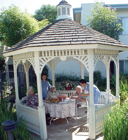 Residents enjoying refreshments in a gazebo
