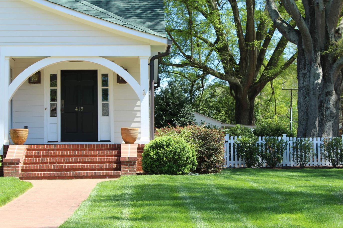Exterior view of a house with a landscaped front yard.