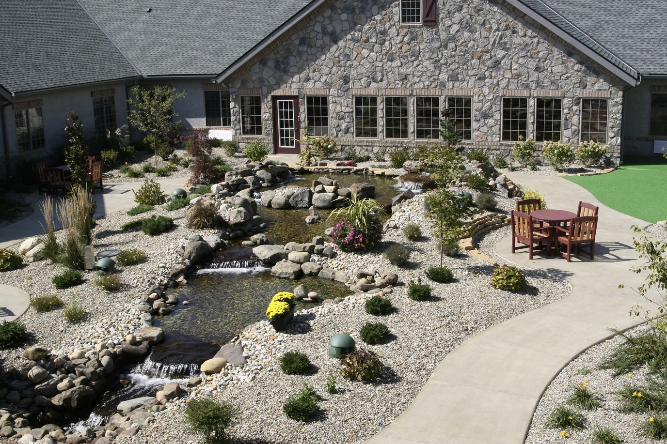 Beautifully landscaped outdoor area with water feature.