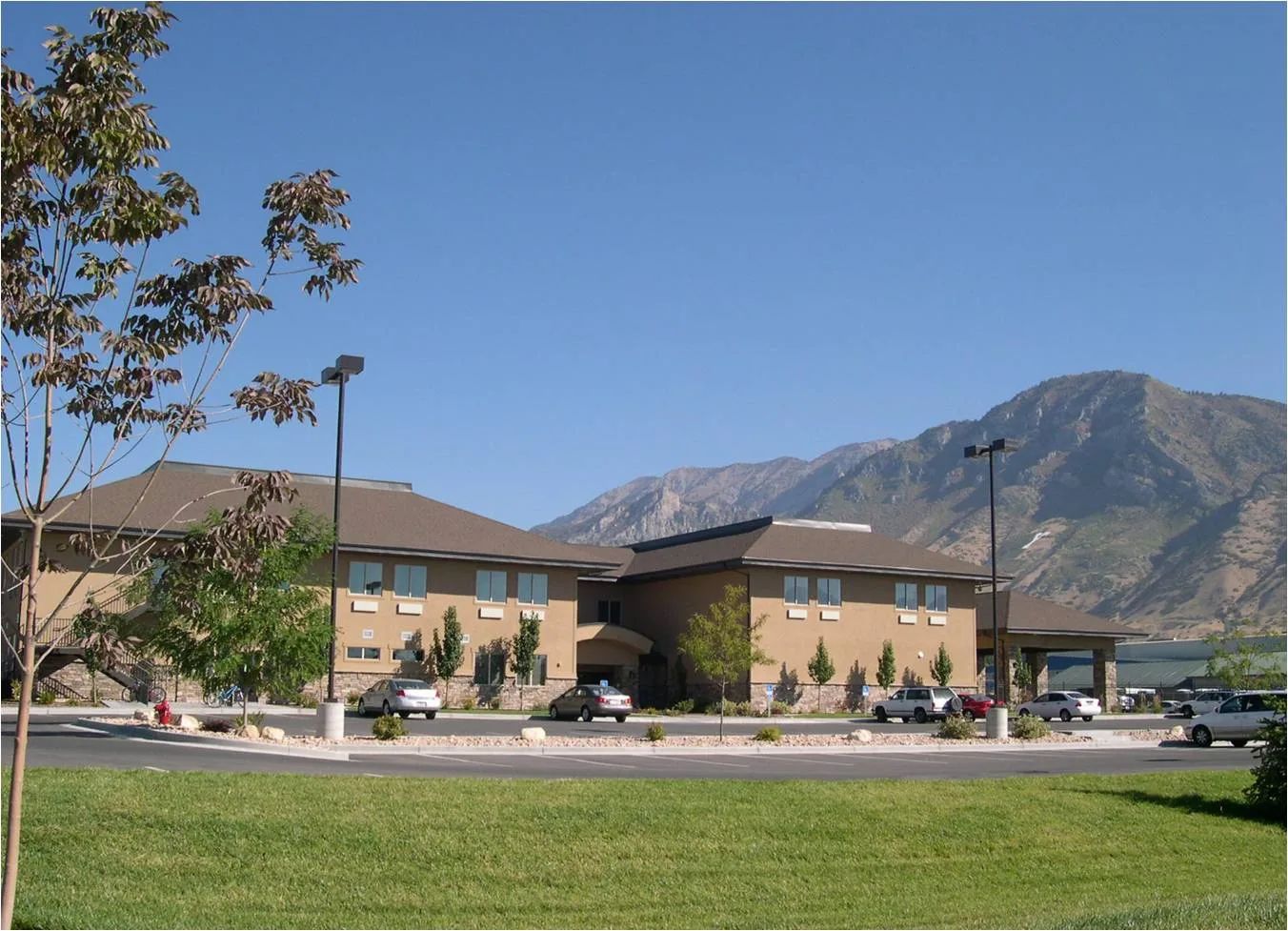 Exterior view of the facility with mountains in background.