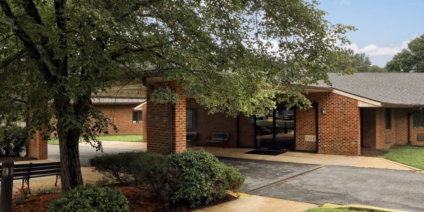 Entrance of La Plata Nursing Home surrounded by greenery.