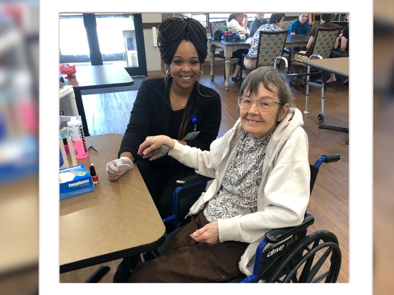 Staff member assisting a resident in a common area