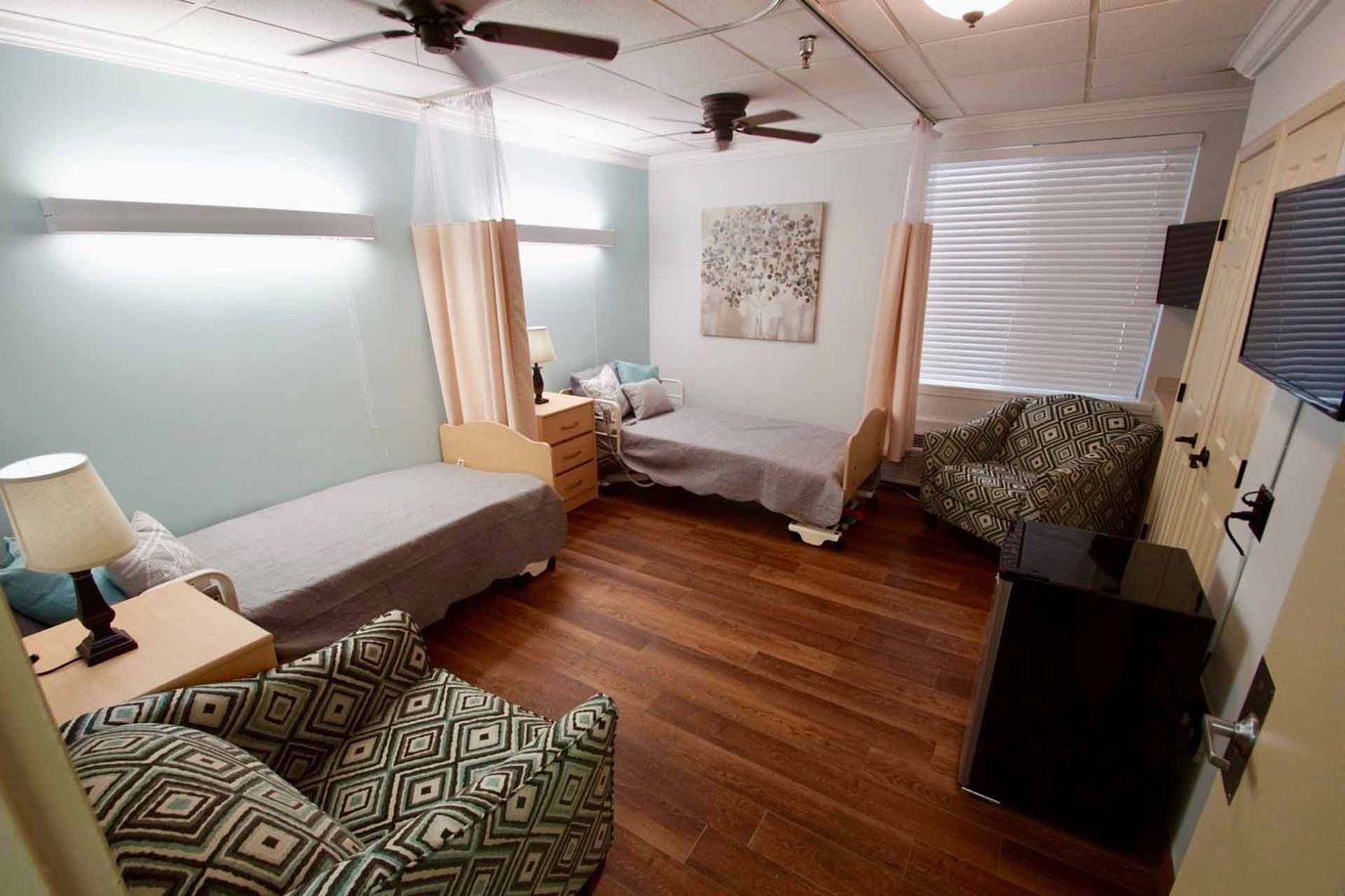 Cozy shared resident room with two beds and seating