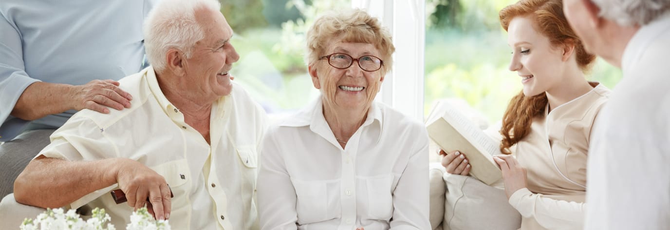 Residents and staff engaging in a warm conversation