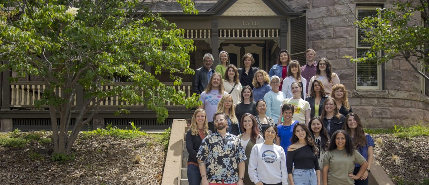 Group photo of staff members outside the facility