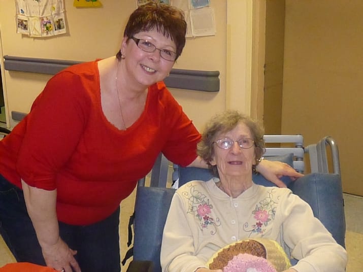 Staff member with a resident in a cozy common area
