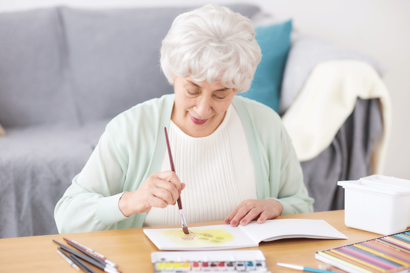 Senior woman painting in an indoor activity space