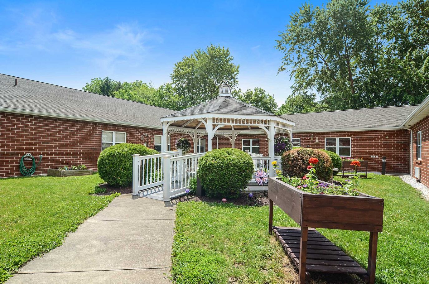 Outdoor gazebo area with landscaped gardens